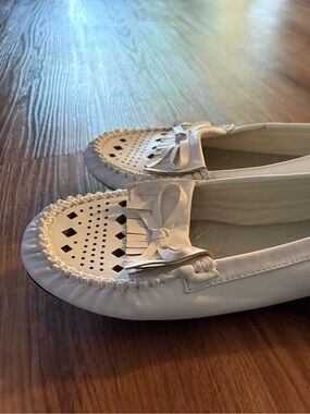 Soft moccasin type shoes in white. Never worn.